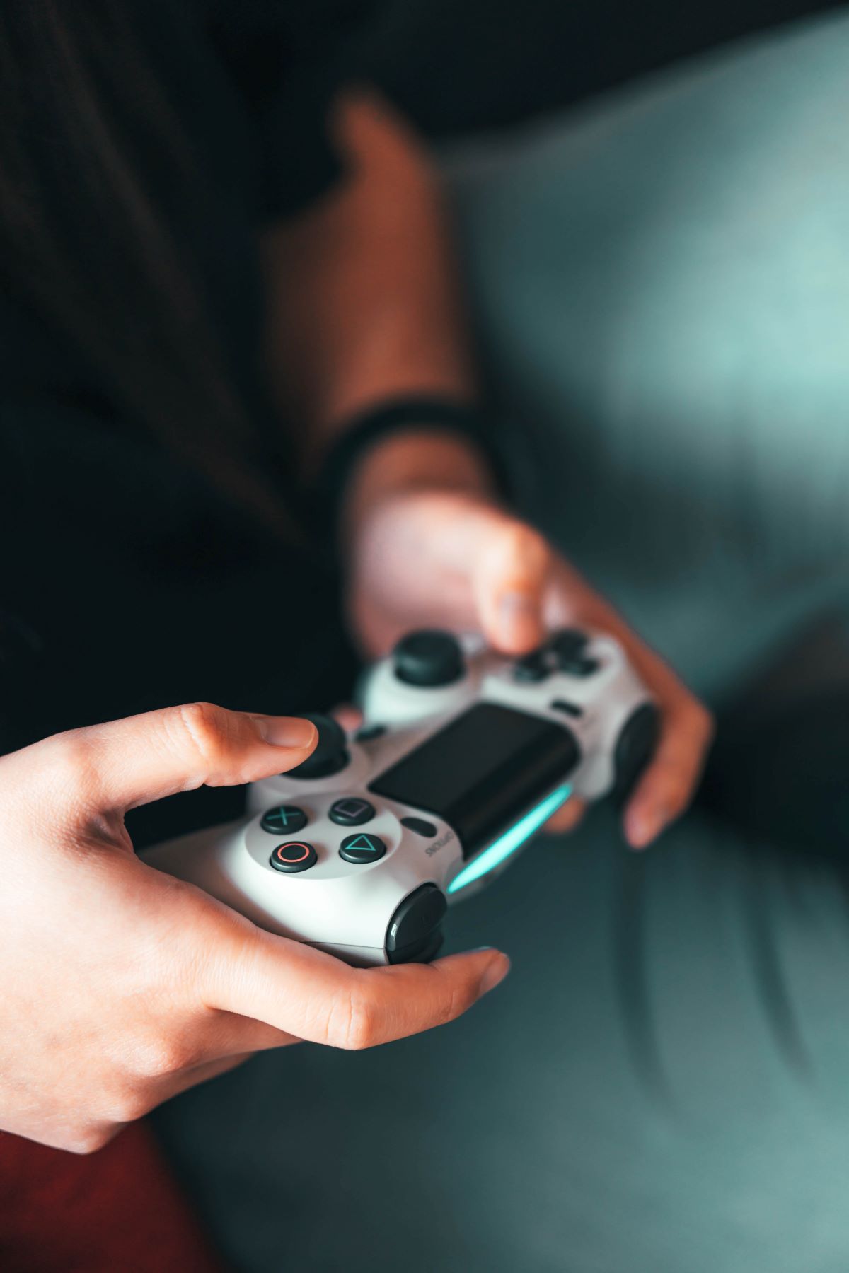 Using a video game controller; photo by Sora Khan on Unsplash