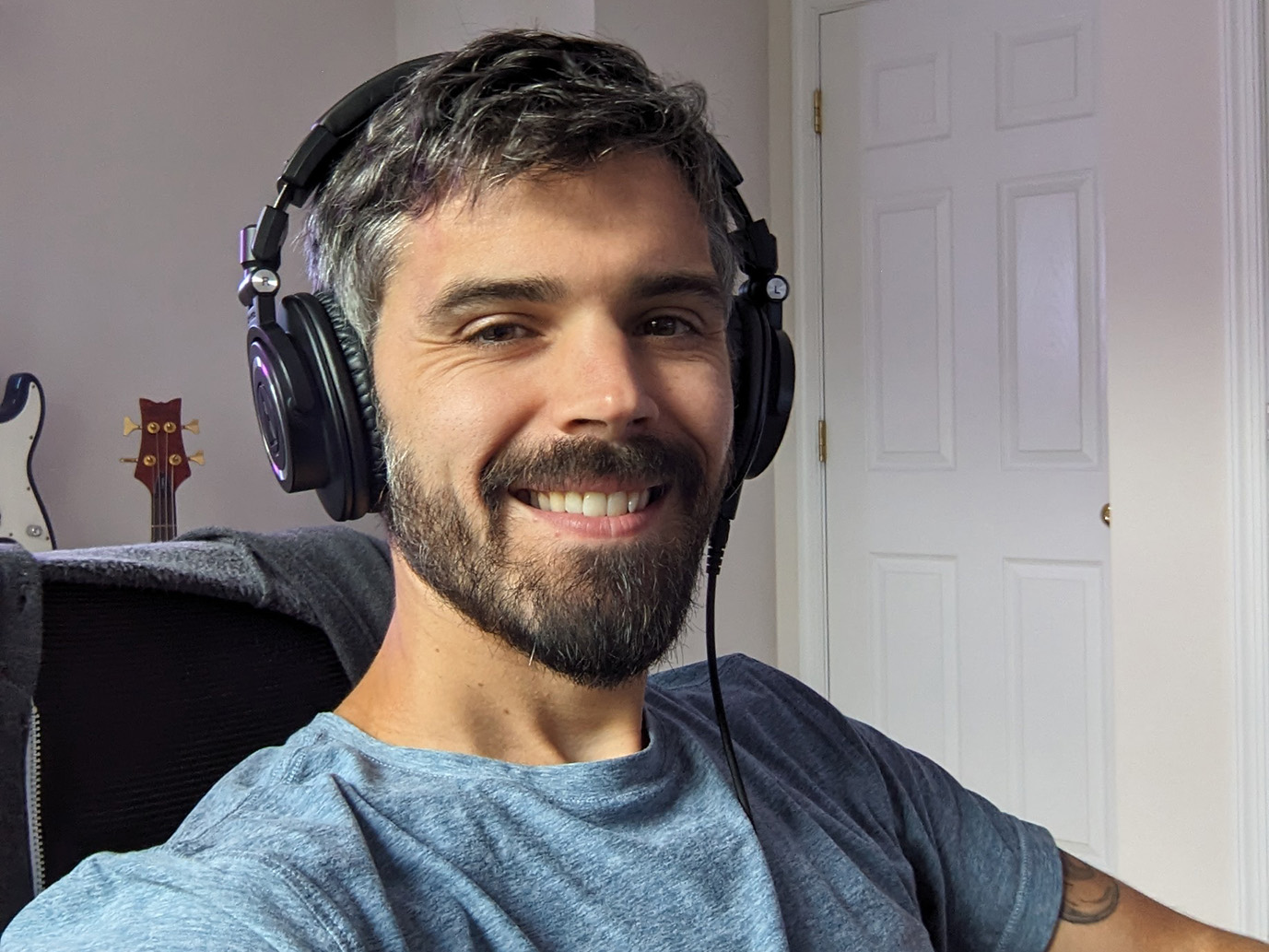 Sean Burns sitting in a chair with headphones on